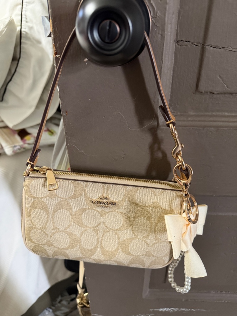 Coach Beige Signature Mini Wristlet with Bow Charm